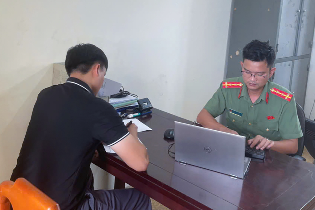 Cảnh sát làm việc với người đàn ông vi phạm. Ảnh: Hùng Lê
